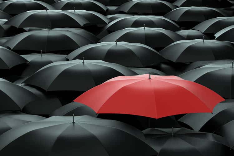 One red umbrella in a bunch of black ones demonstrates the concept of a focal point ©Sashkin - stock.adobe.com