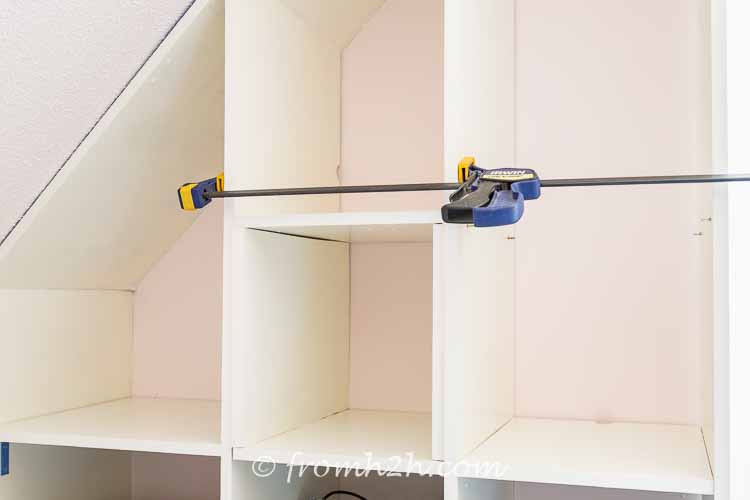 Attach the shelves to the side supports | DIY Bonus Room Bookshelves And Window Bench
