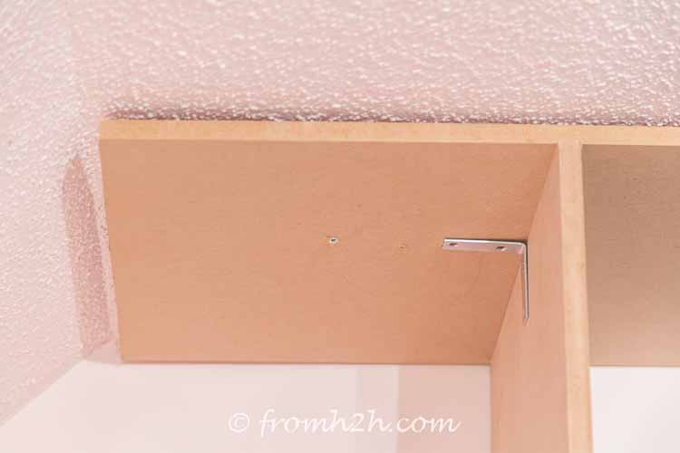 Screw the top shelf to the ceiling | DIY Bonus Room Bookshelves And Window Bench