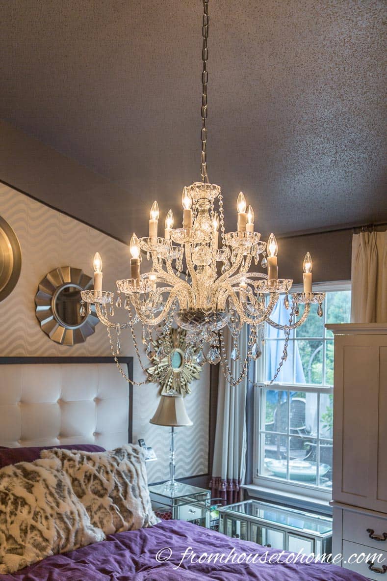 Chandelier hung above a bed