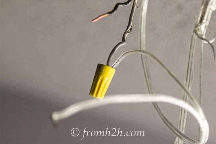 Screw on a wire nut | How to Hang a Chandelier