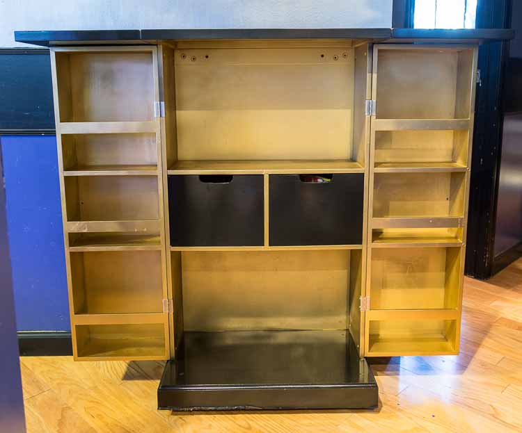 The inside of the bar cabinet spray painted gold | DIY Hollywood Regency Bar Cabinet Makeover