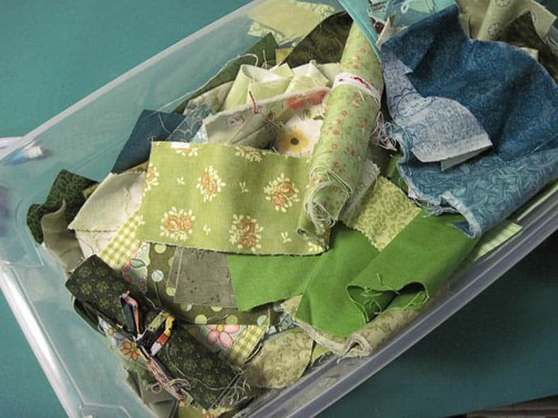 Use clear storage boxes to store fabric scraps by color via withinaquarterinch.com