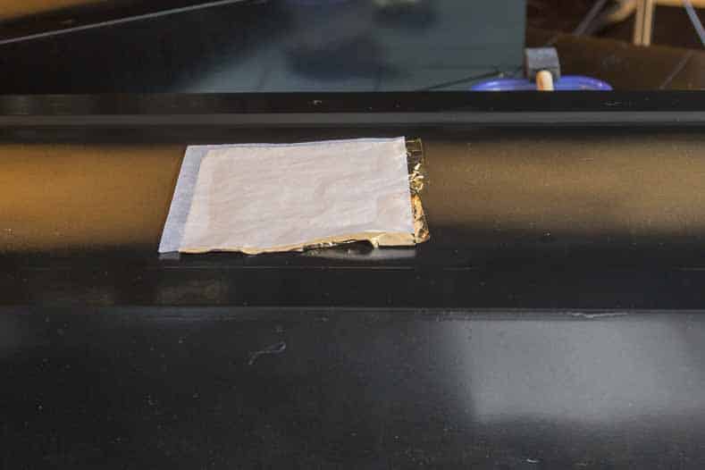 Gold leaf sheet sticking to gold leaf adhesive