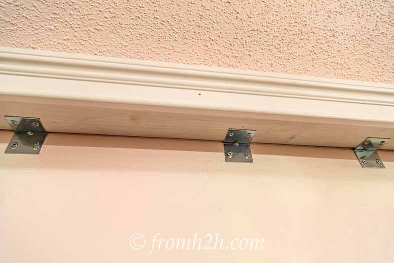 Install Angle brackets under the top rail