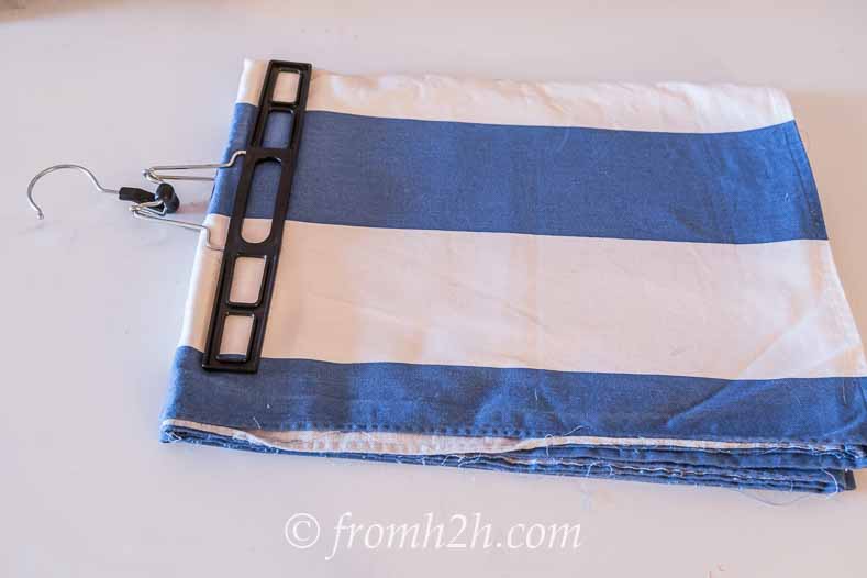 Use skirt hangers | DIY Fabric Storage Ladder