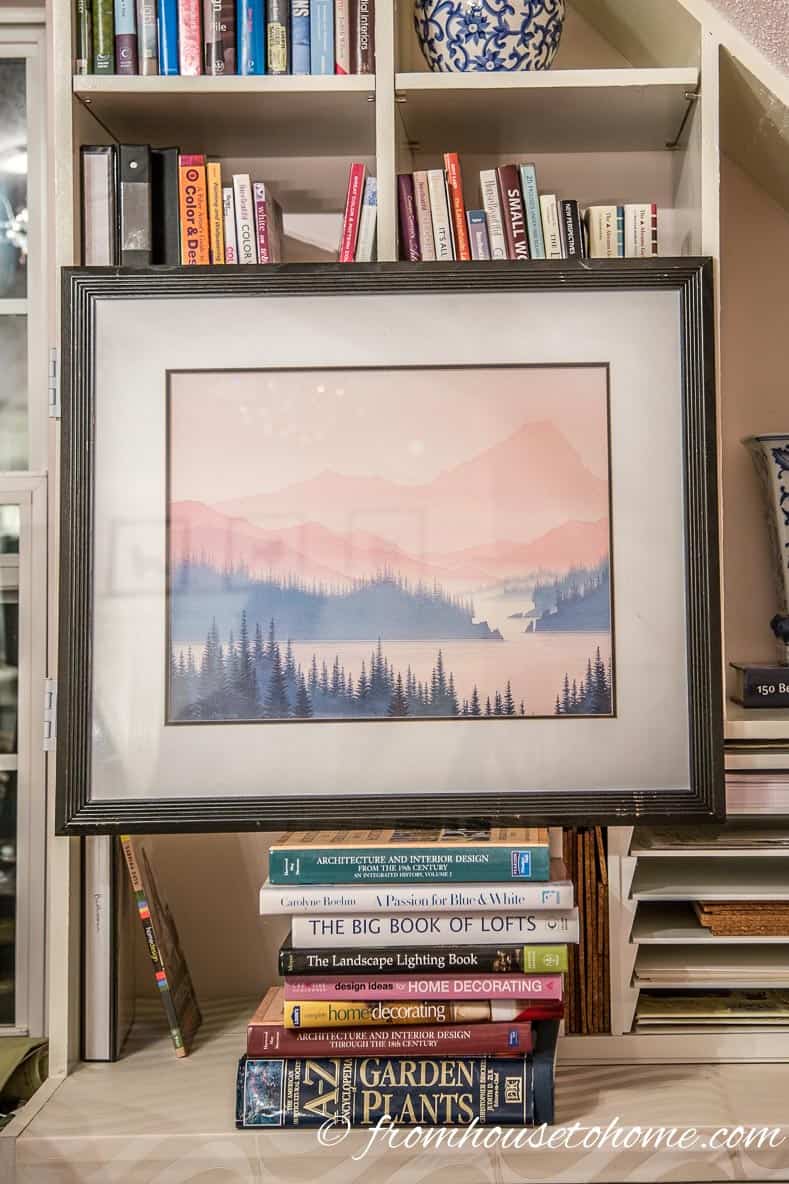 Decide where the picture should be placed | How To Hang Art On A Bookcase (And Still Have Easy Access To The Books)