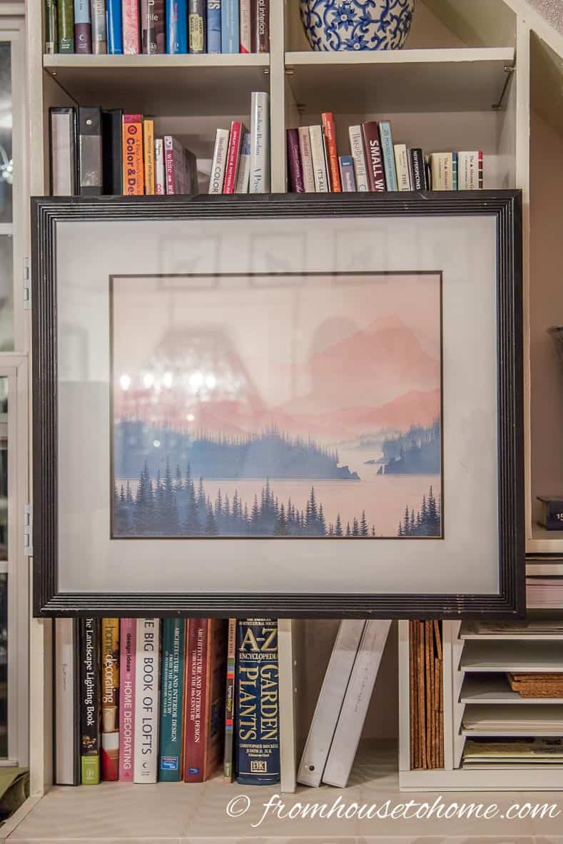 The closed picture | How To Hang Art On A Bookcase (And Still Have Easy Access To The Books)