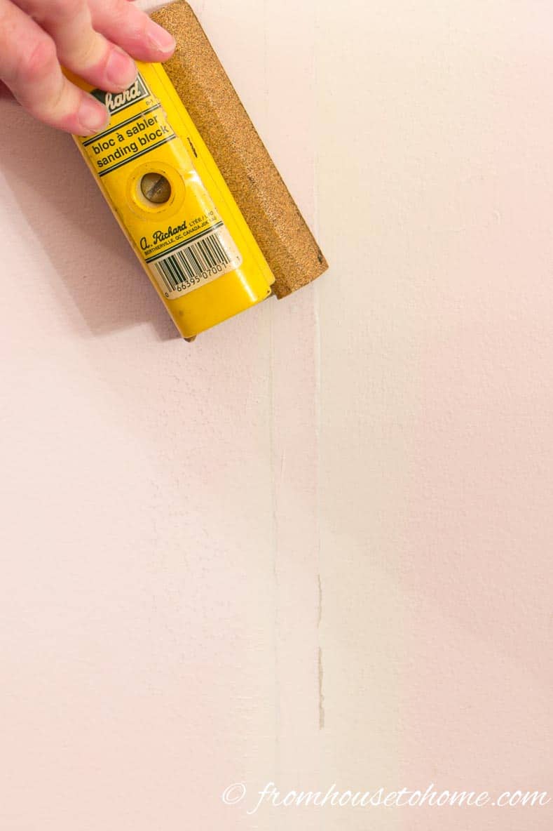 Use a sanding block to remove any extra spackle