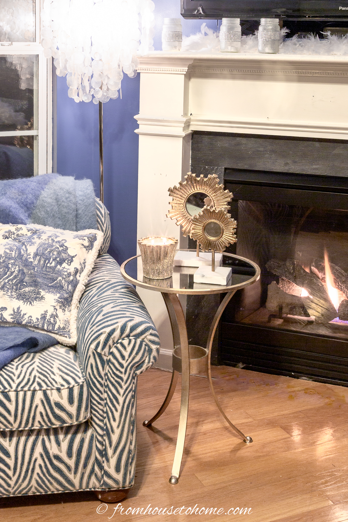 Blue and white arm chair beside the fireplace