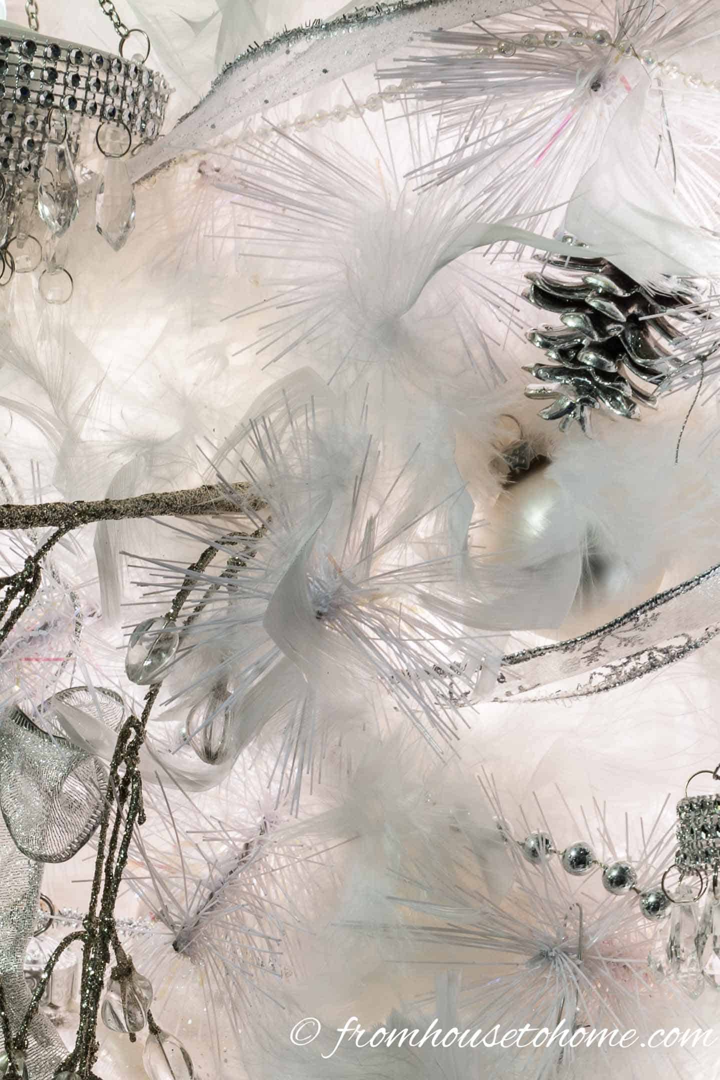 White feather boas woven into the branches of an all white Christmas tree