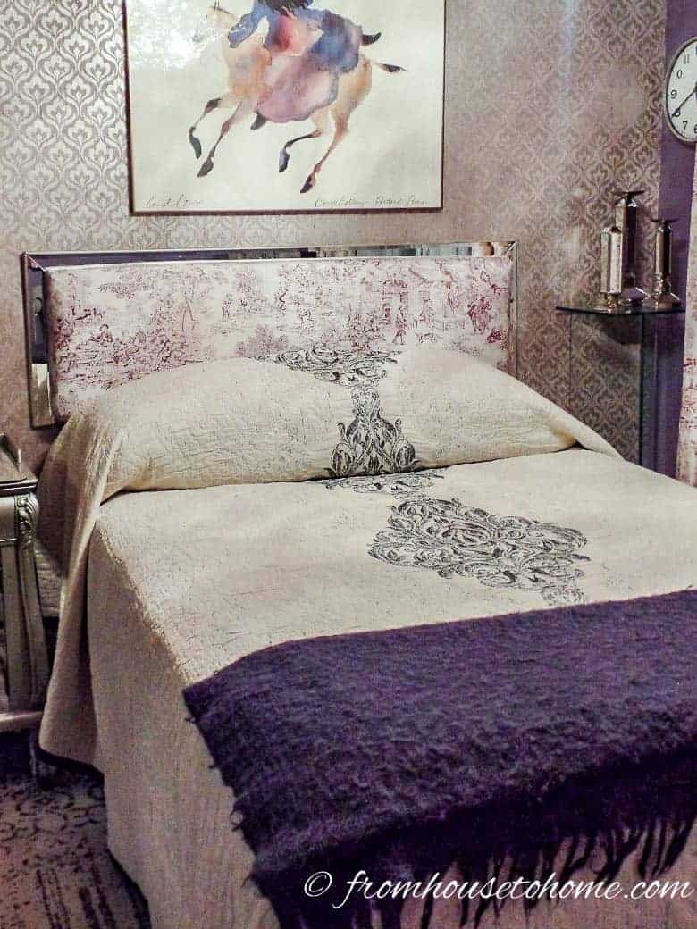The gray and purple quilt on the bed