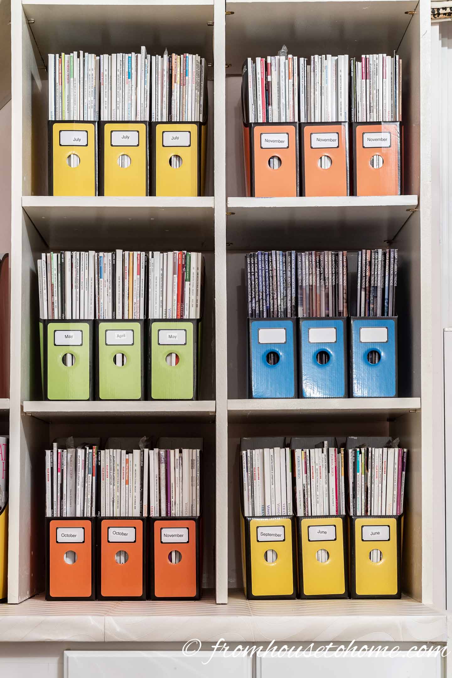 Magazines in color-coordinated magazine boxes on a shelf
