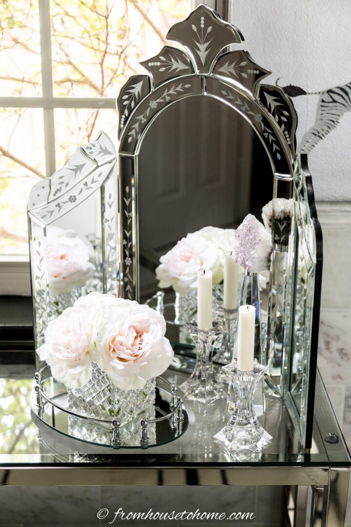 A freestanding mirror in front of a window