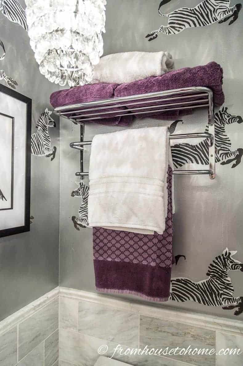 Towels stored on an over-the-toilet shelf