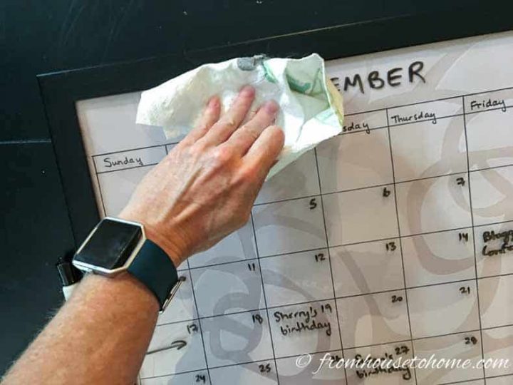 DIY dry erase calendar being wiped off