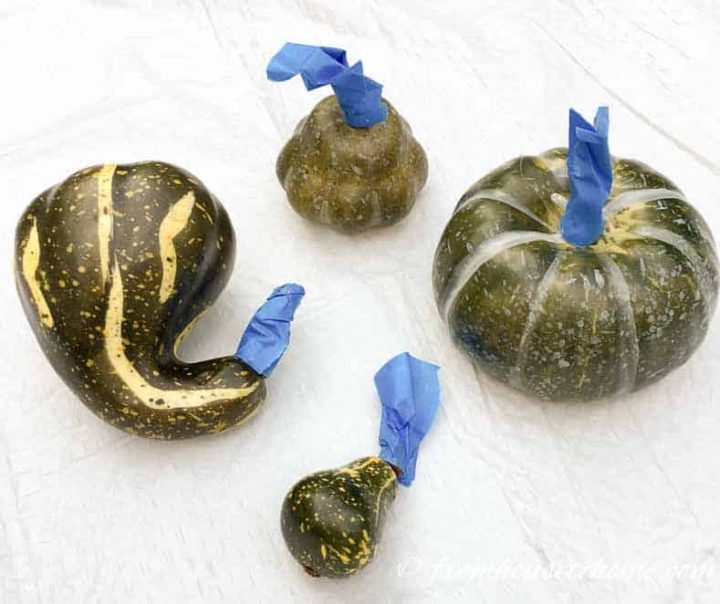 Faux pumpkins and gourds with the stems taped with painter's tape