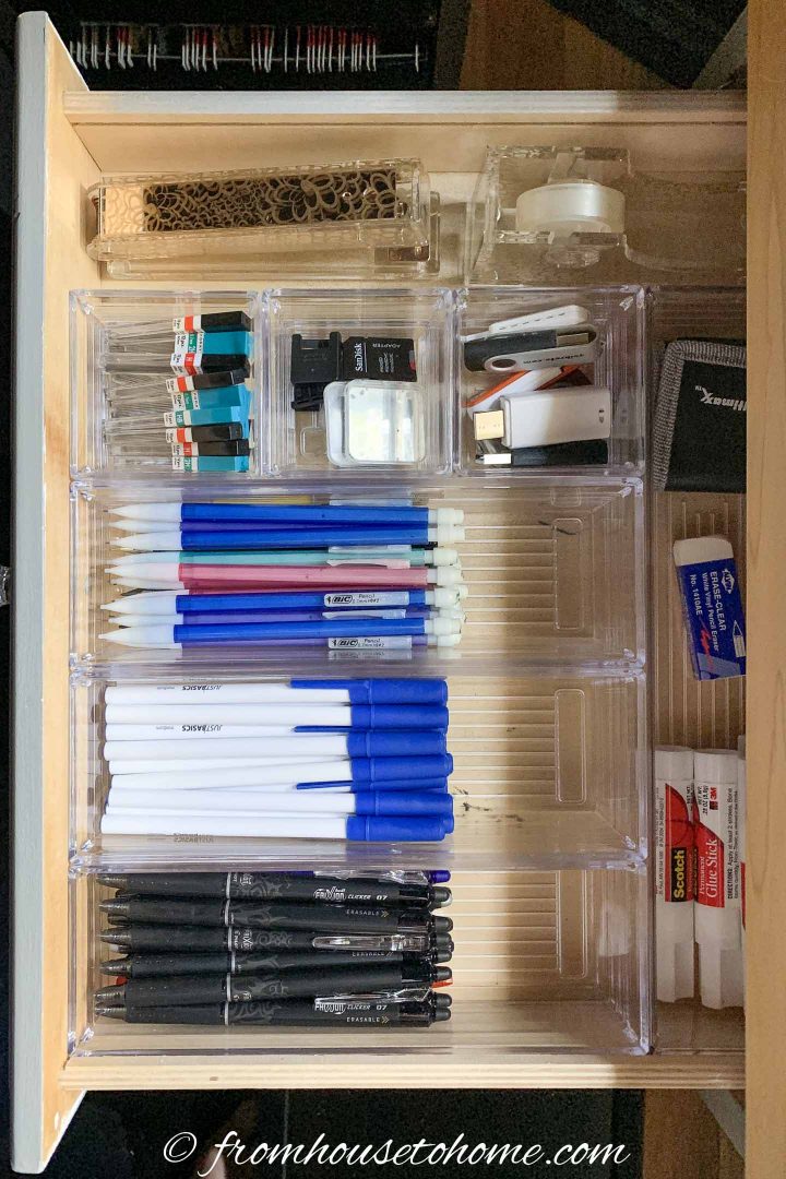 Draw organizers in a desk drawer with pencils, pens and other office supplies