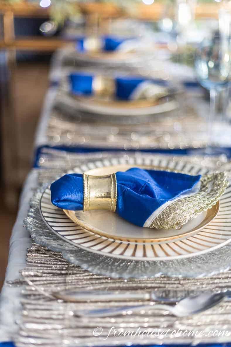 Side view of a blue, white and gold Christmas table setting