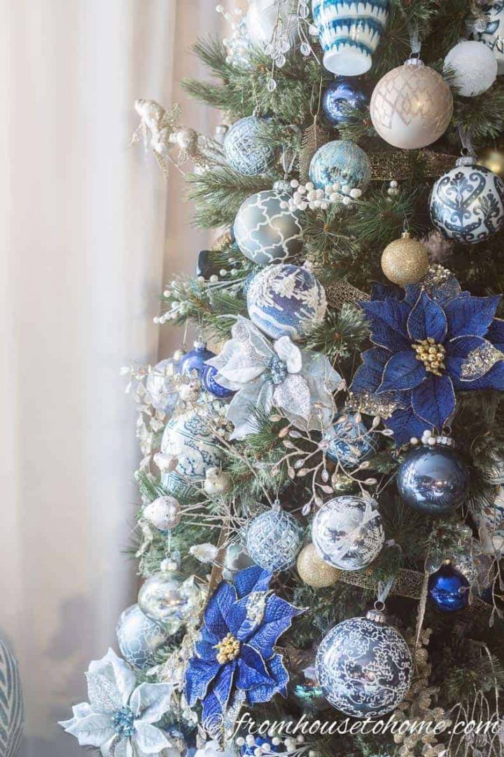 Blue, white and gold Christmas ornaments on the tree 