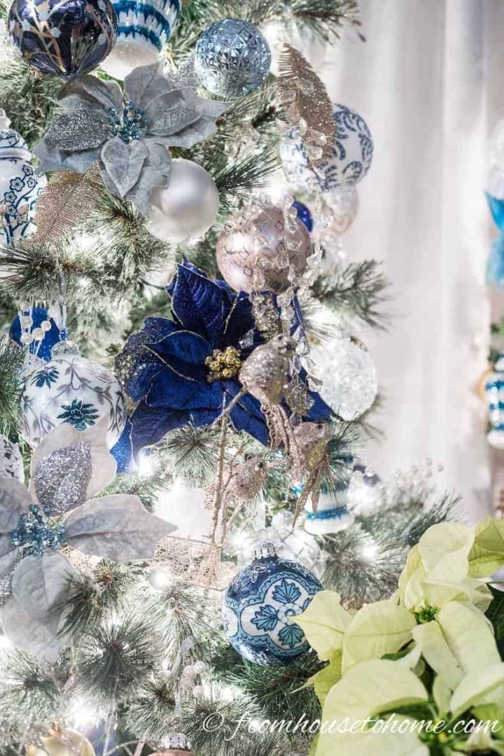 Blue poinsettia ornaments on the Christmas tree 