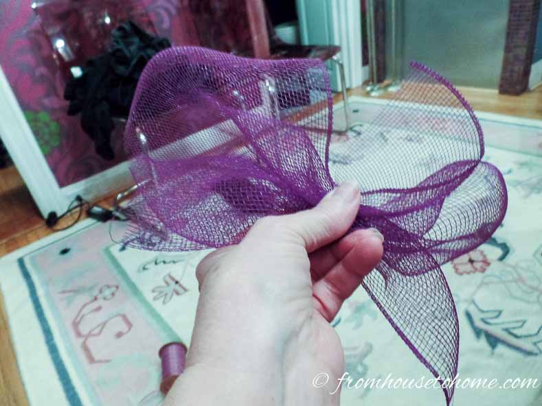 Scrunch the mesh as if you were making a bow