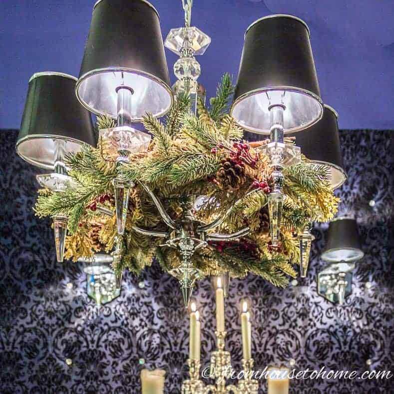 Chandelier decorated with an evergreen garland for Christmas