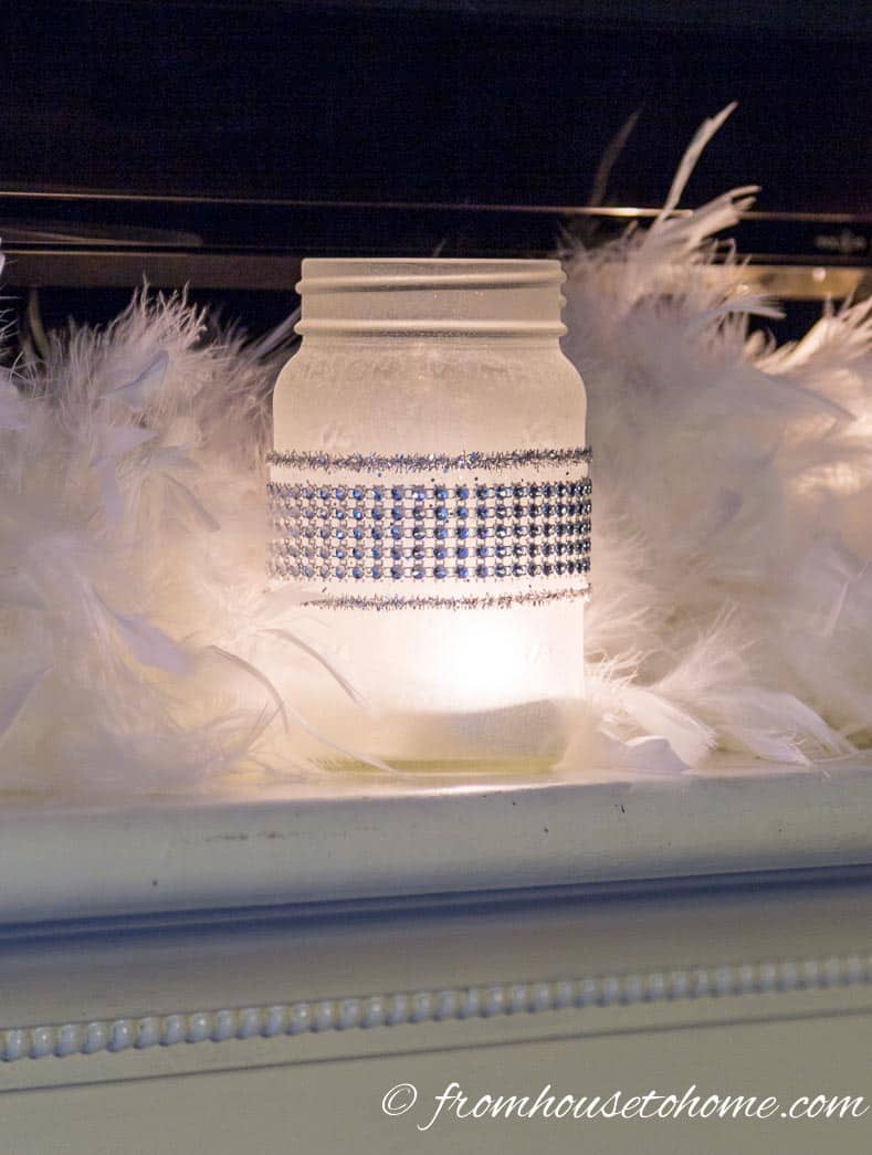 Frosted glass candle holder on fireplace mantel