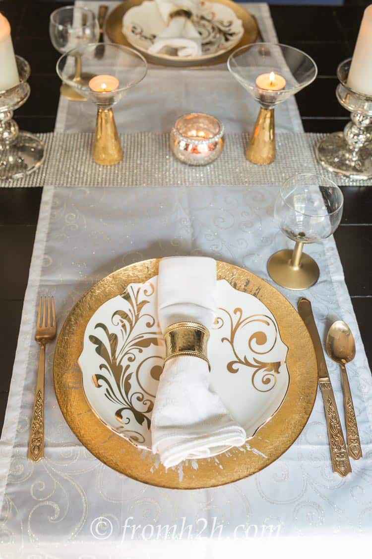 DIY gold stemmed wine glasses on a gold and white Christmas table setting
