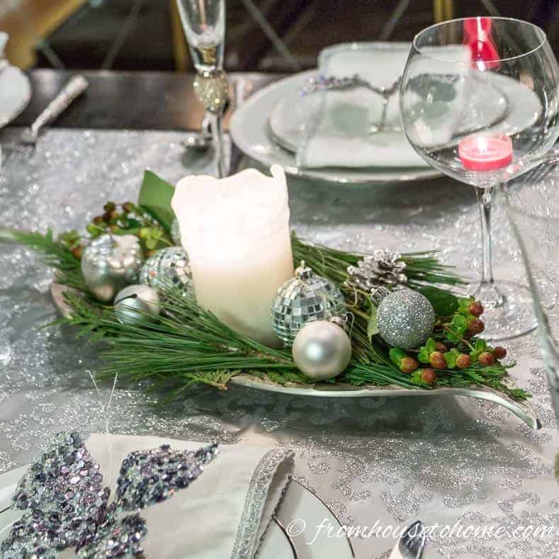 Last Minute Christmas table centerpiece with evergreen branches, ornaments and a candle