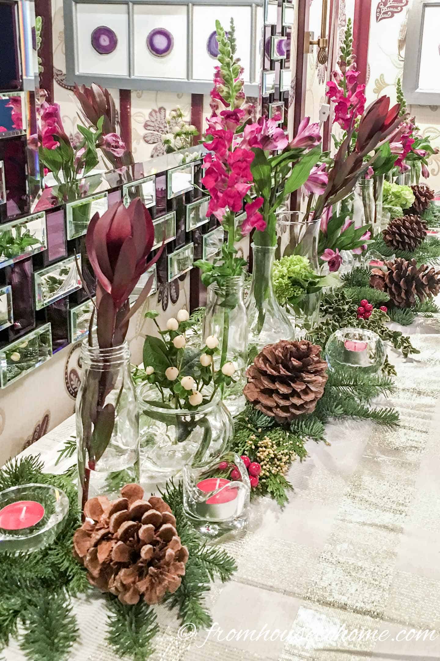 Evergreens, pine cones and candles as a Christmas centerpiece