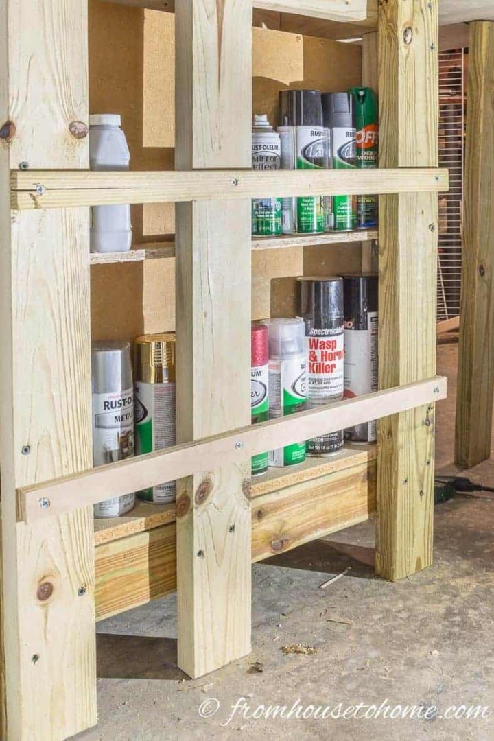 Nail a small board across the front to keep the cans from falling over
