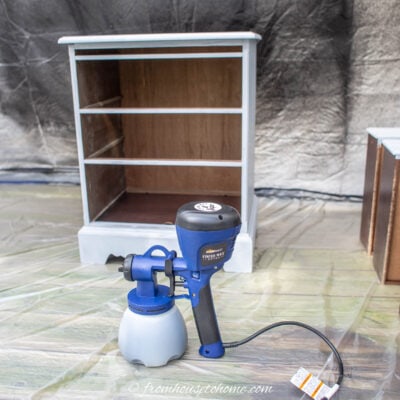 paint sprayer in front of a piece of furniture