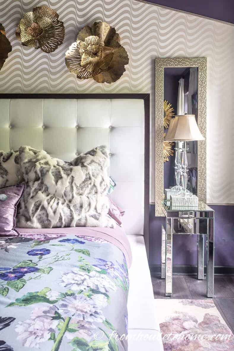 Gold accessories add some glamour to the purple master bedroom
