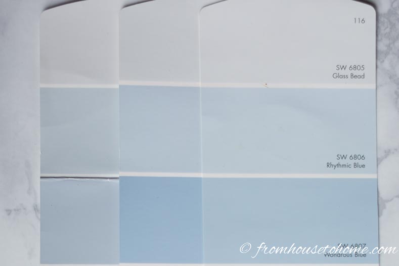 three paint chips with light blue colors