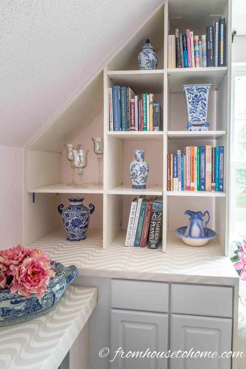Blue and white ginger jars on a white shelf