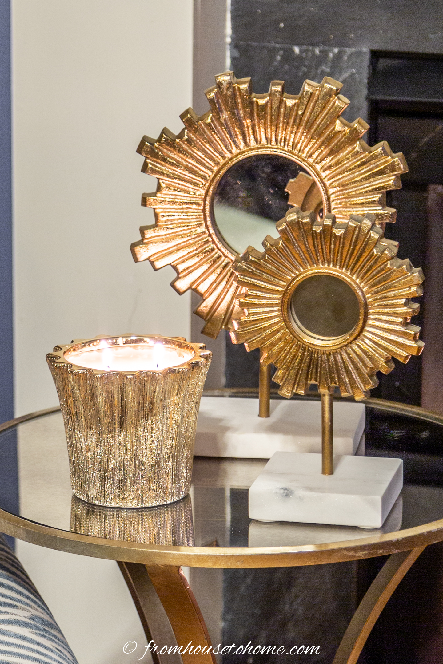 gold candle holder and small mirrors on a table
