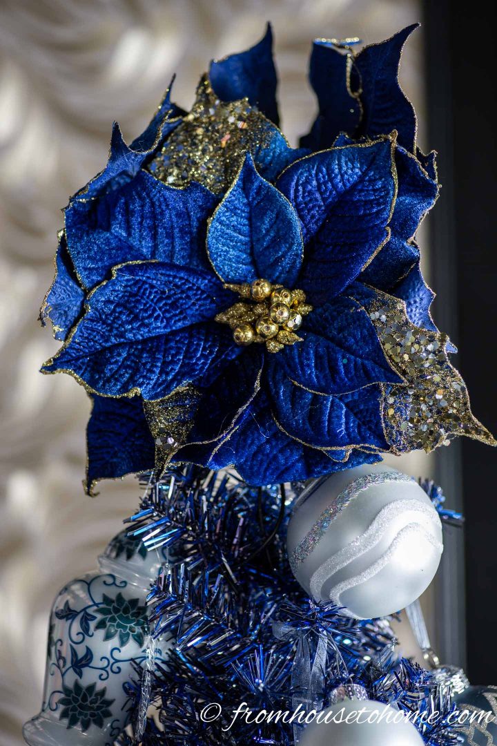 Blue poinsettia ornament as a Christmas tree topper