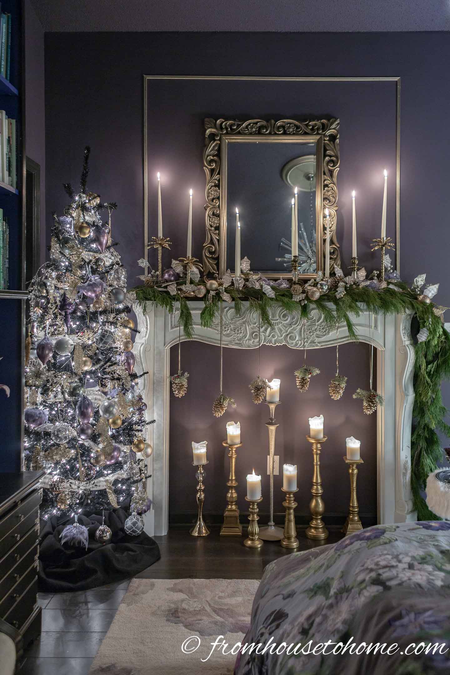 Purple and gold Christmas tree beside a white fireplace mantel decorated with evergreens