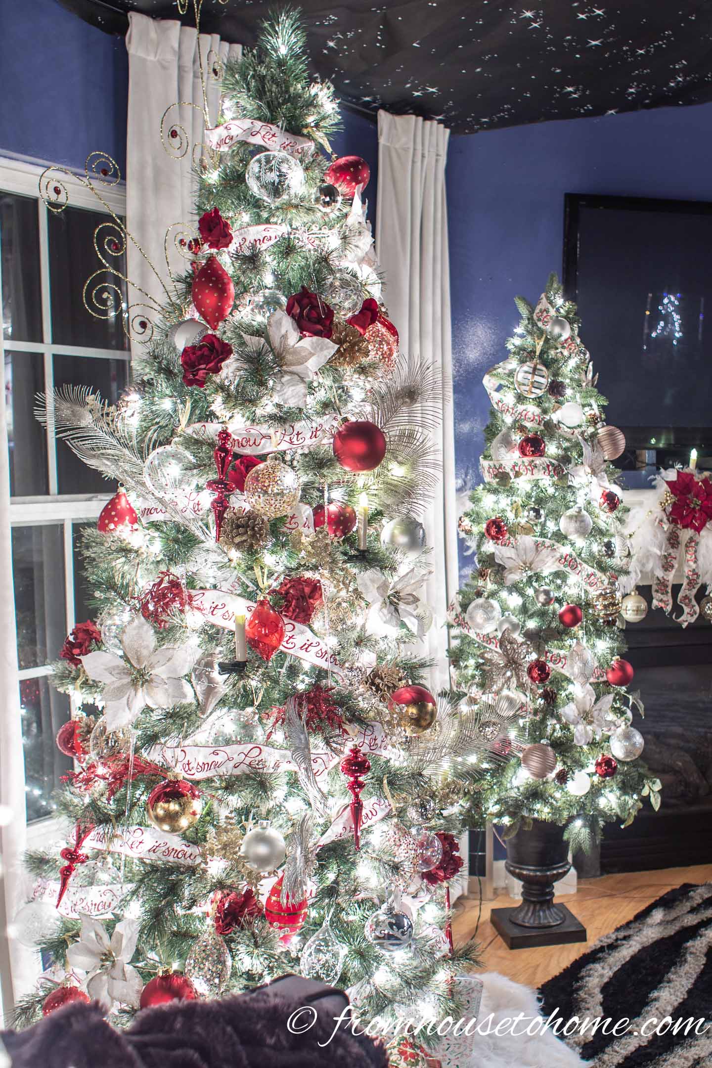 Two Christmas trees decorated with red, white and gold ornaments