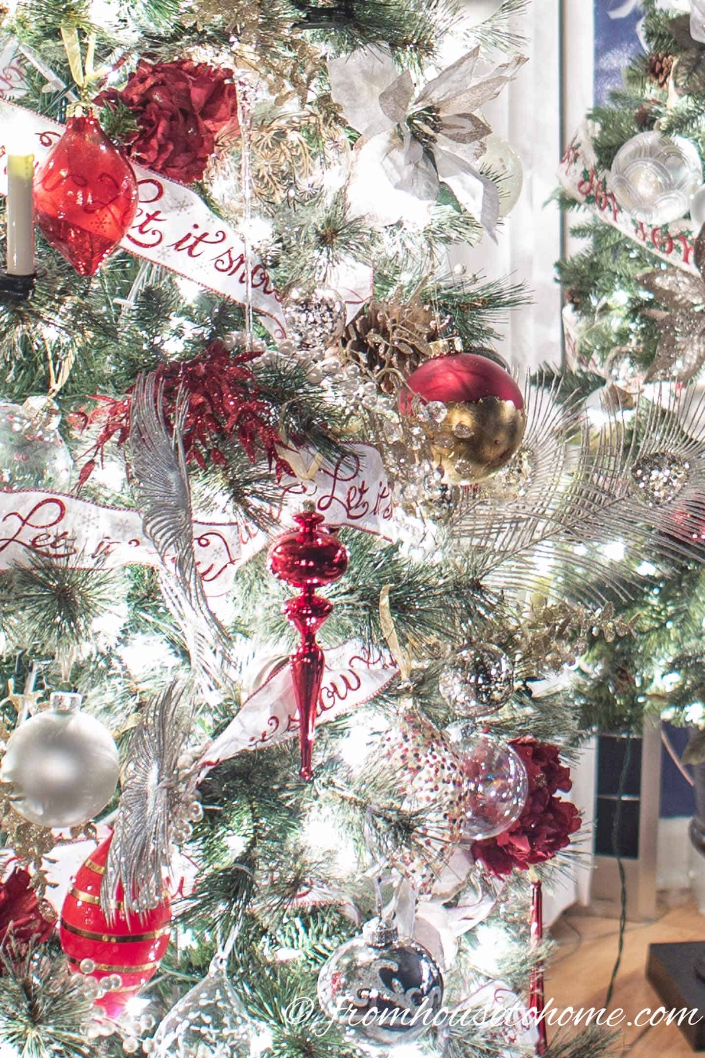 Close up of the red, white and gold ornaments and ribbons on a Christmas tree