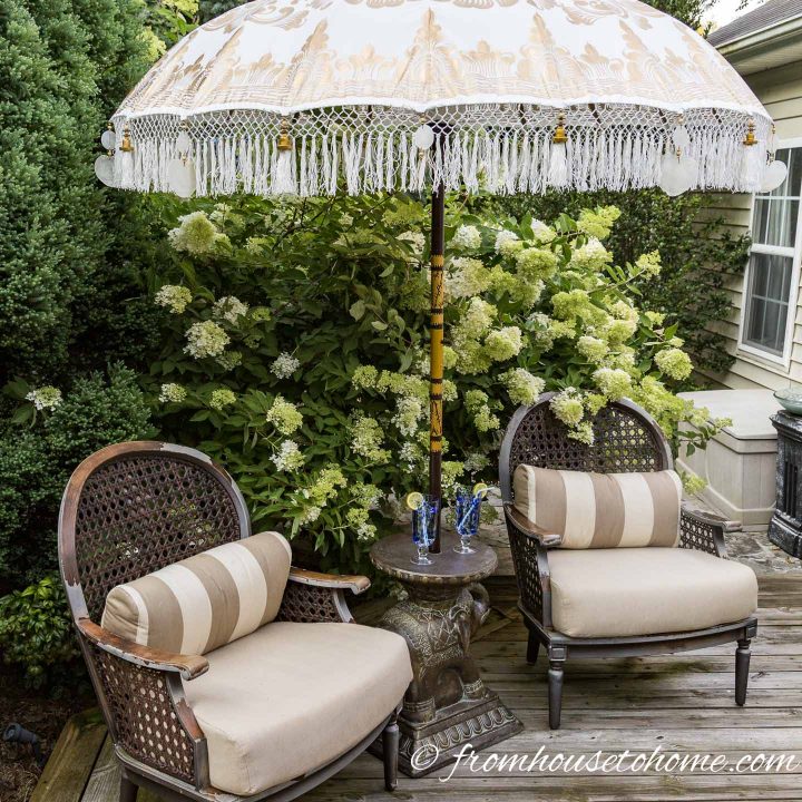 two chairs on a deck with an umbrella