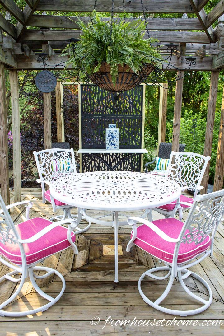 White painted metal patio furniture on a deck