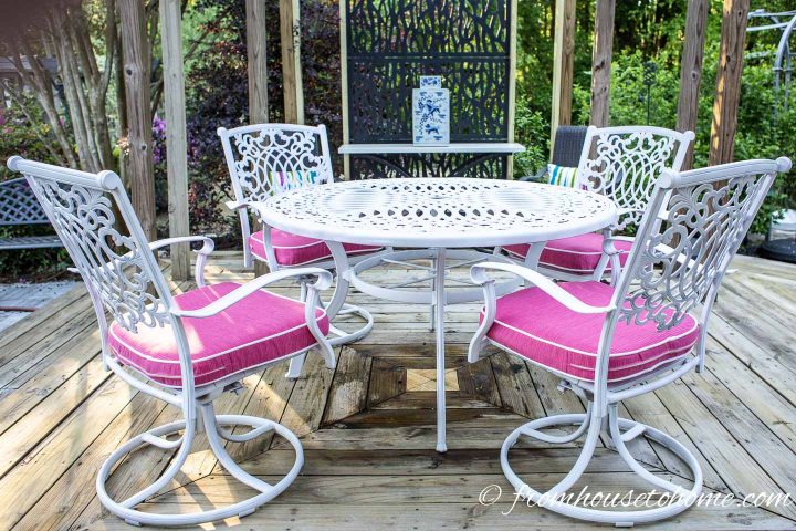 Metal outdoor furniture spray painted white with fuchsia pink cushions