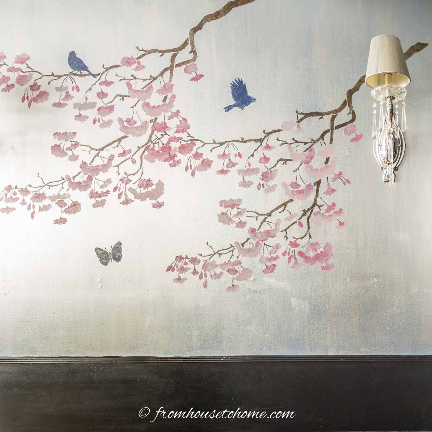 Wall stenciled with cherry trees to look like Chinoiserie wallpaper