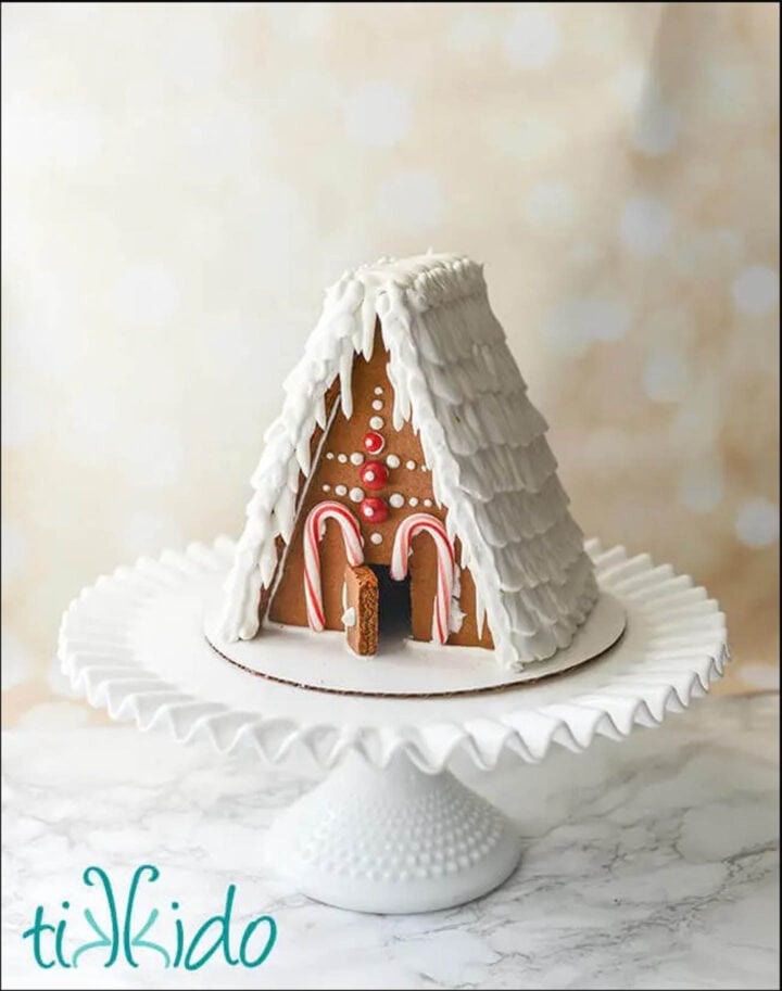 gingerbread house on a white cake plate