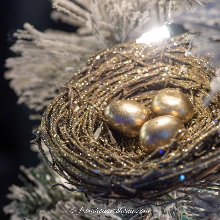 DIY gold bird's nest ornament in a Christmas tree