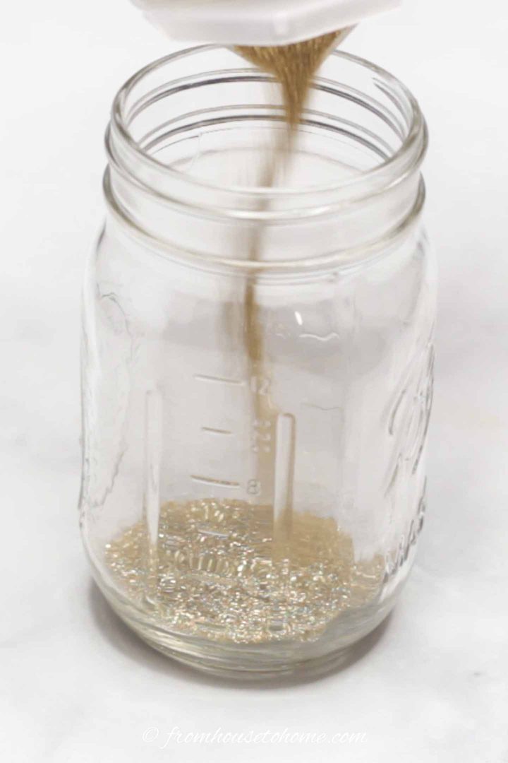 Fine glitter being poured into a mason jar
