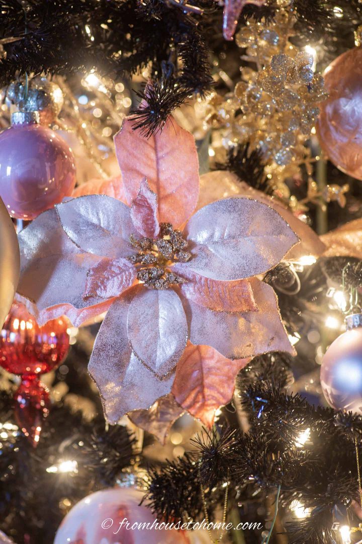Pink poinsettia on a black Christmas tree