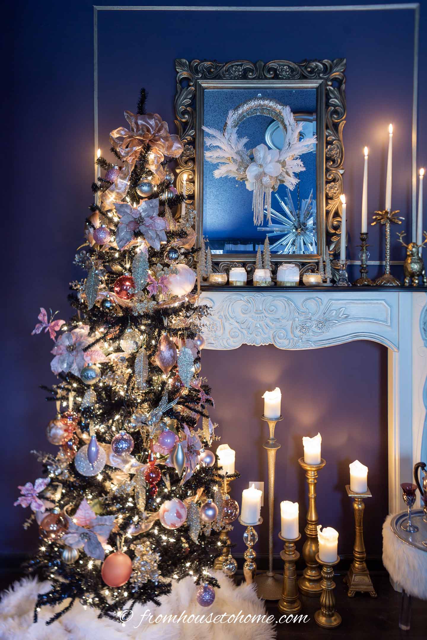 Black, pink and gold Christmas tree in front of a white fireplace mantel